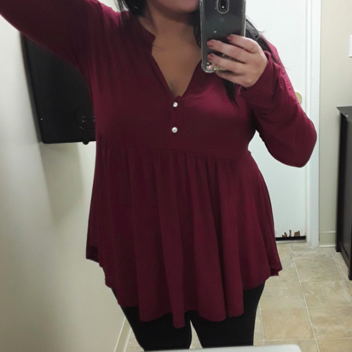 A reviewer wearing the top in wine red