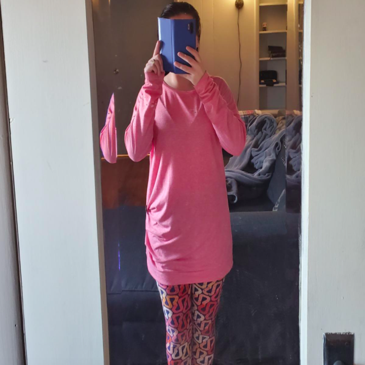 A reviewer wearing the top in pink