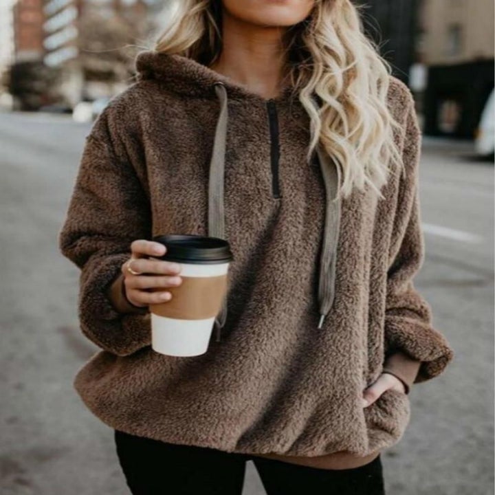 A model wearing the pullover in brown