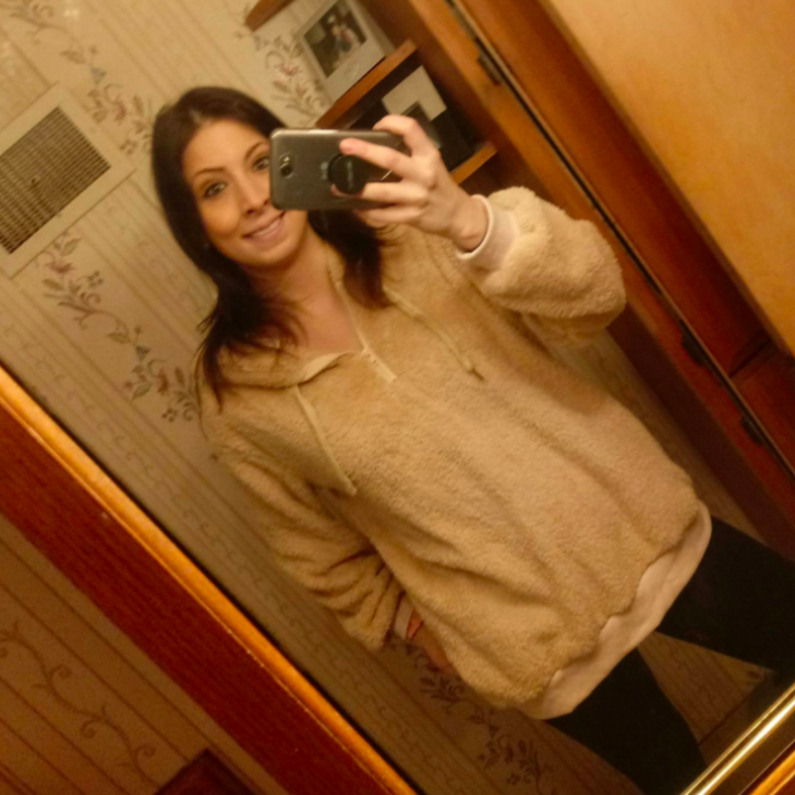 A reviewer wearing the pullover in khaki