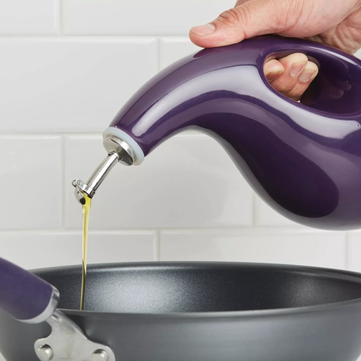 A purple stoneware olive oil container with a smooth pour spout