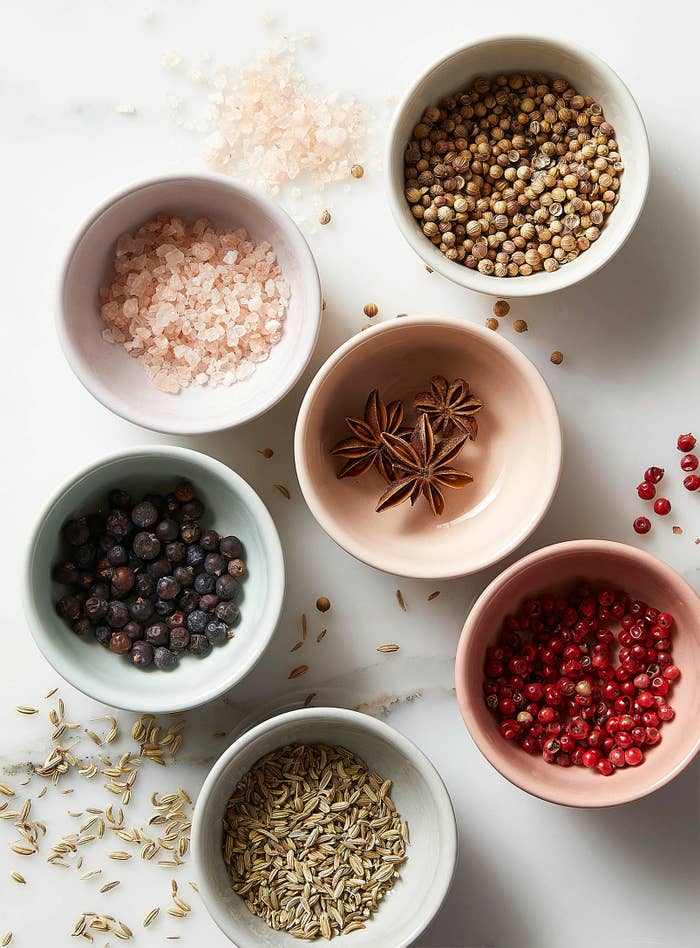 A set of six bowls filled with different ingredients on a counter
