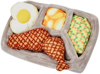Plus Dinner tray with two pieces of chicken, an egg, mashed potatoes, and carrots with peas – all removable