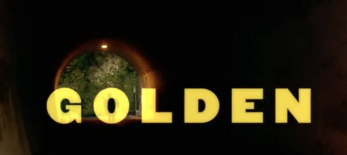 The word &#x27;golden&#x27; is written out in golden letters in front of a tunnel