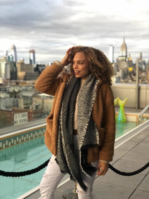 Reviewer wearing the faux fur jacket with large pockets in light brown