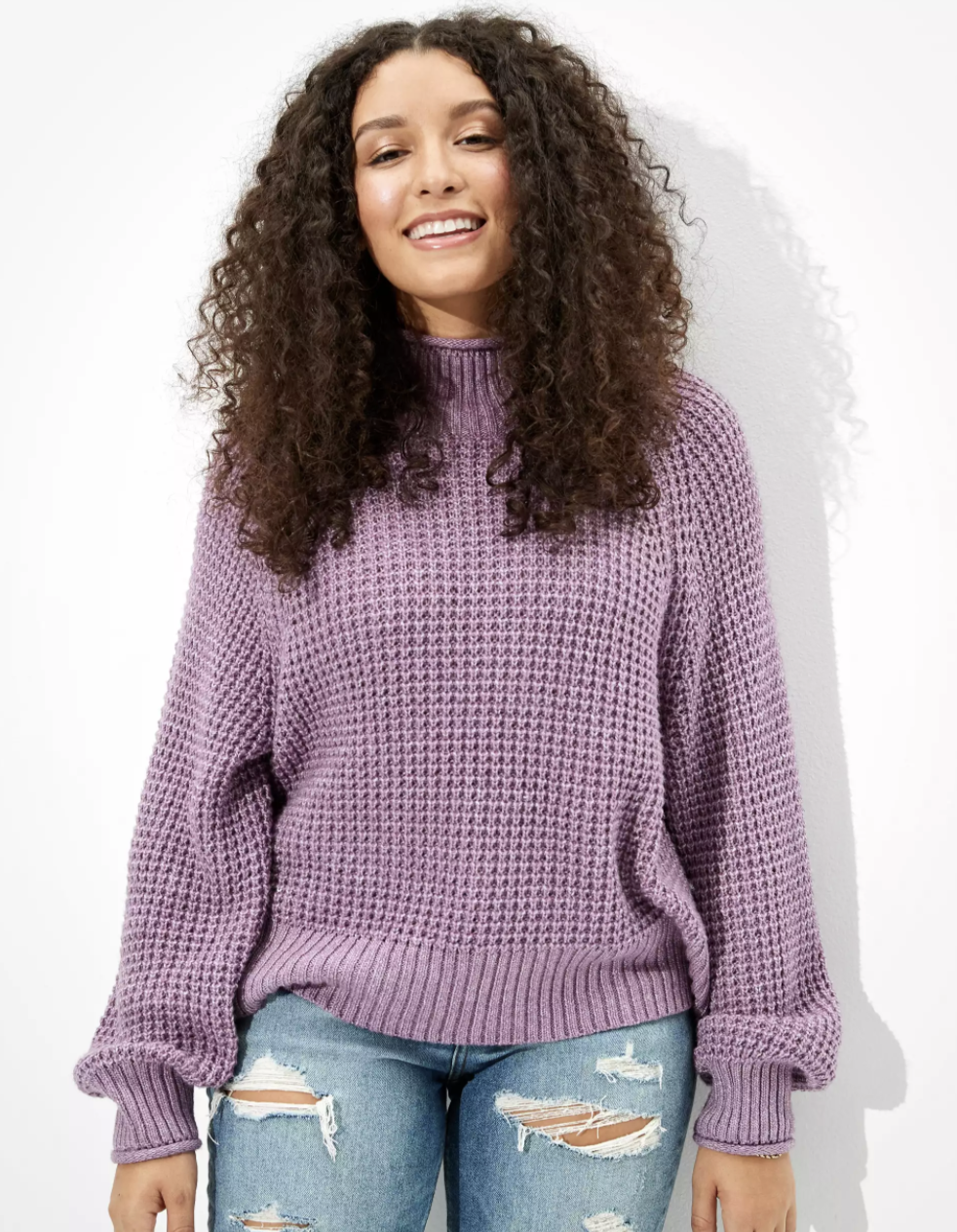 A model wearing the sweater in lilac