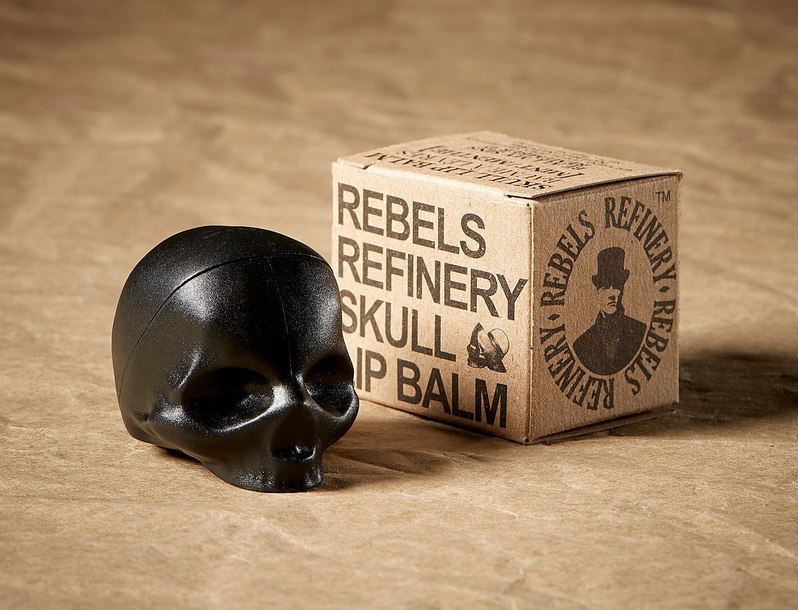 A skull-shaped lip balm next to the box it came in
