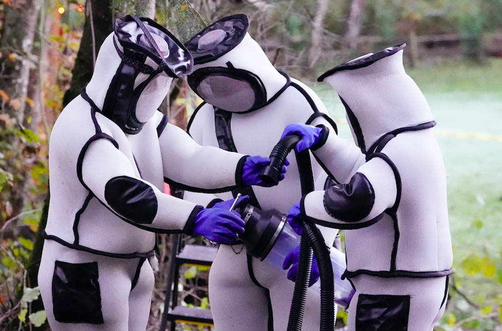 A picture of the scientists together in a group in their thick suits