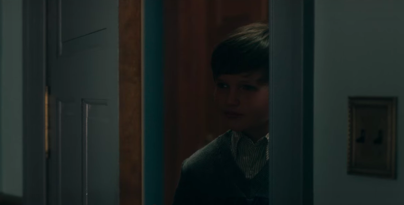 Benjamin Evan Ainsworth as Miles looks through a doorway