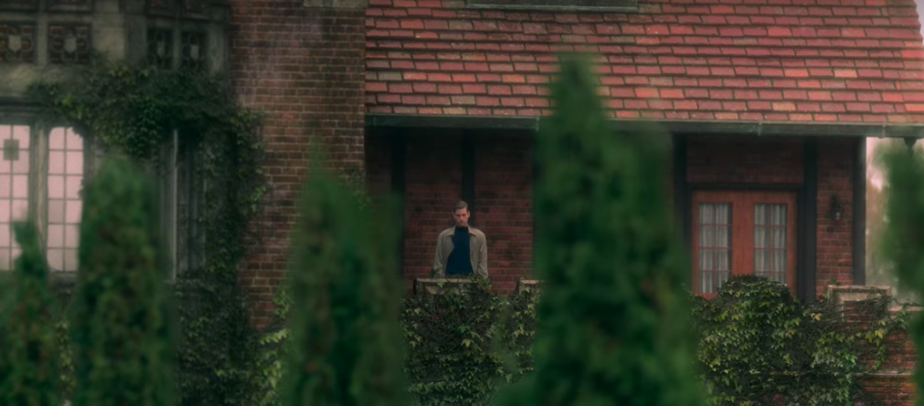 Man standing on a porch in the distance