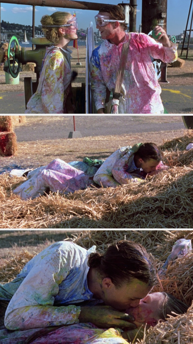 Kat and Patrick falling into the hay and kissing while covered in paint from their game