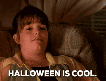A girl leaning forward and saying &quot;Halloween is cool&quot;