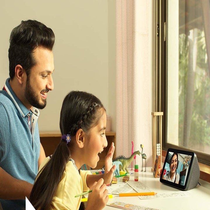A father and daughter duo video calling her mother.