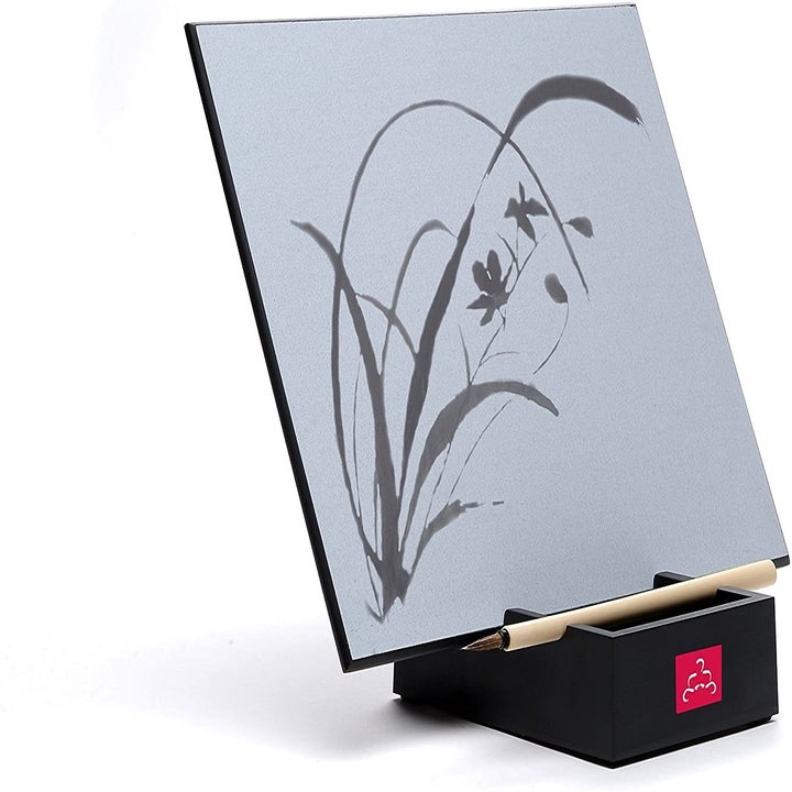 Gray board on black base with floral art