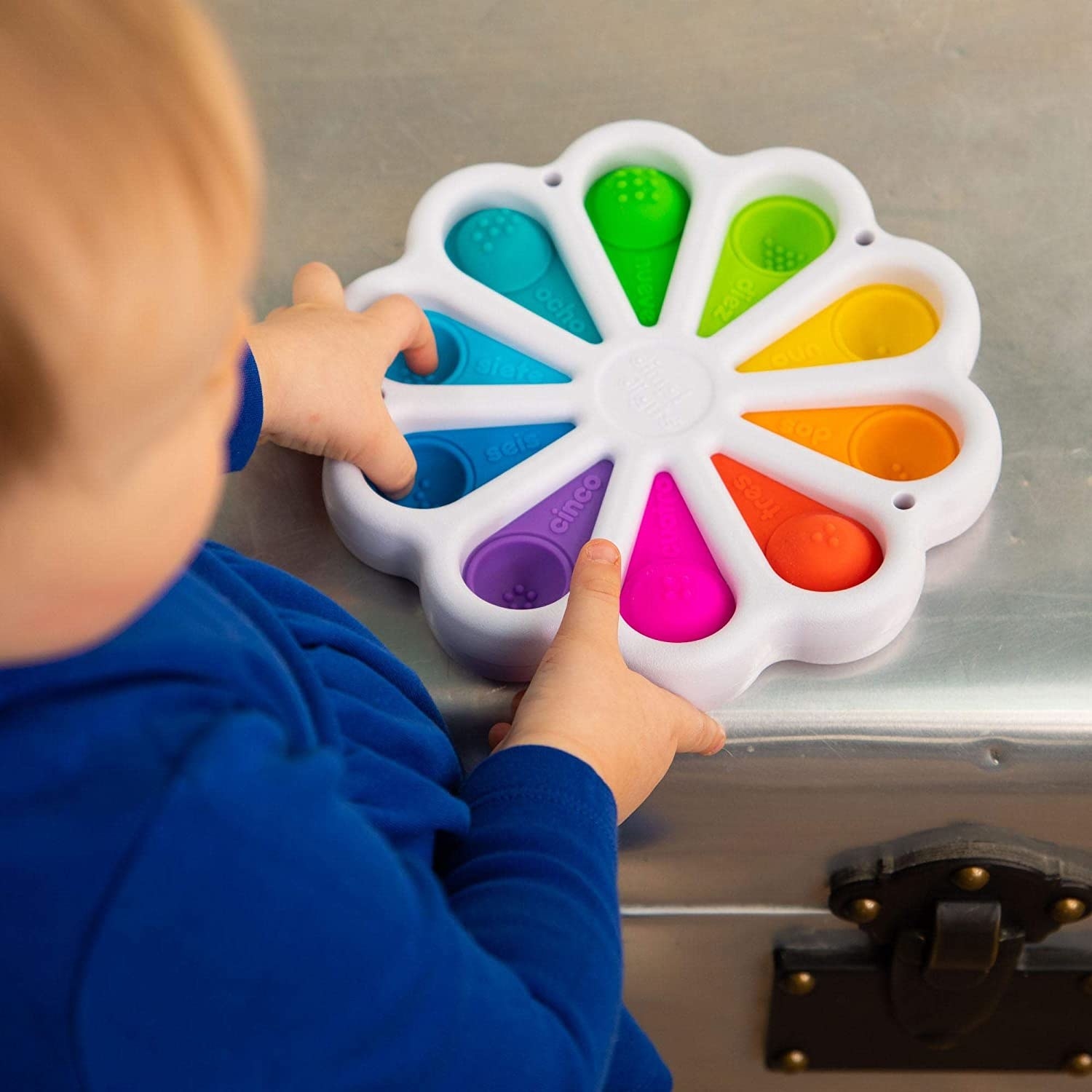 Child model playing with colorful wheel of Dimpl Digits