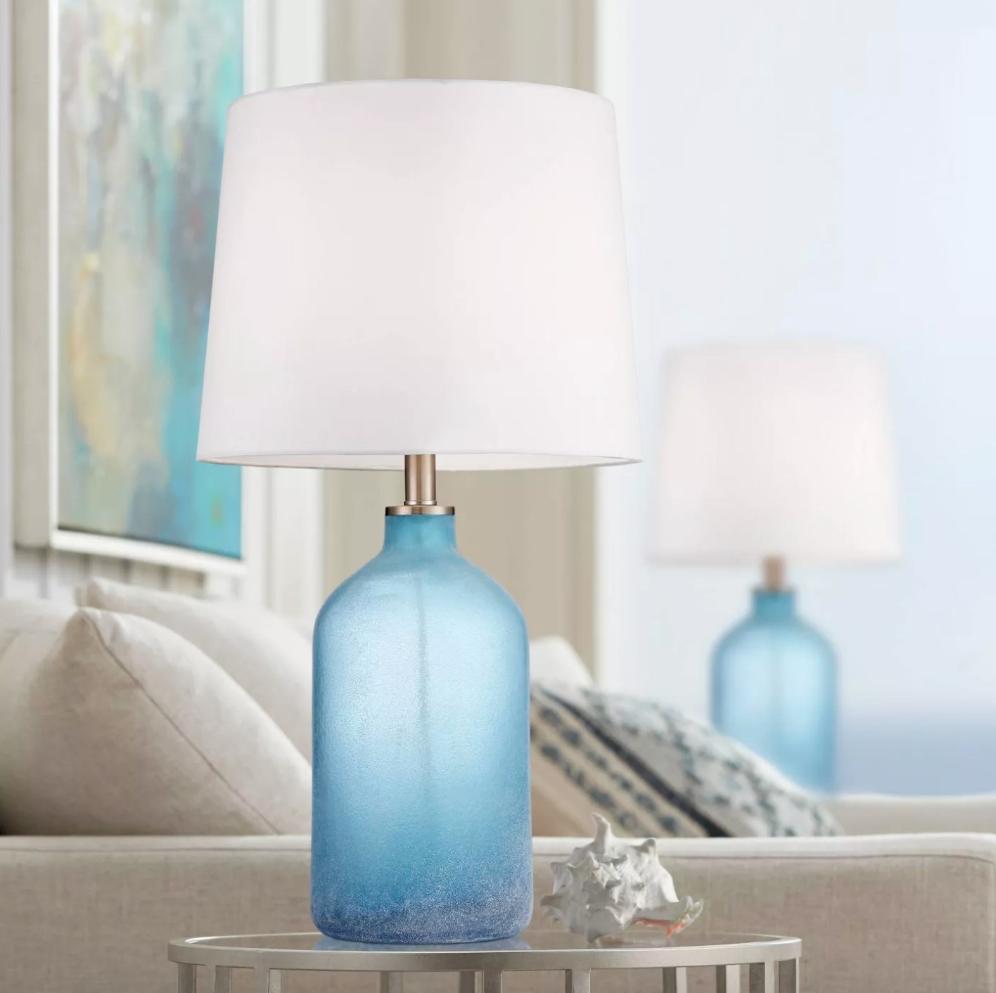 The set of two blue lamps with a glass base and white shade