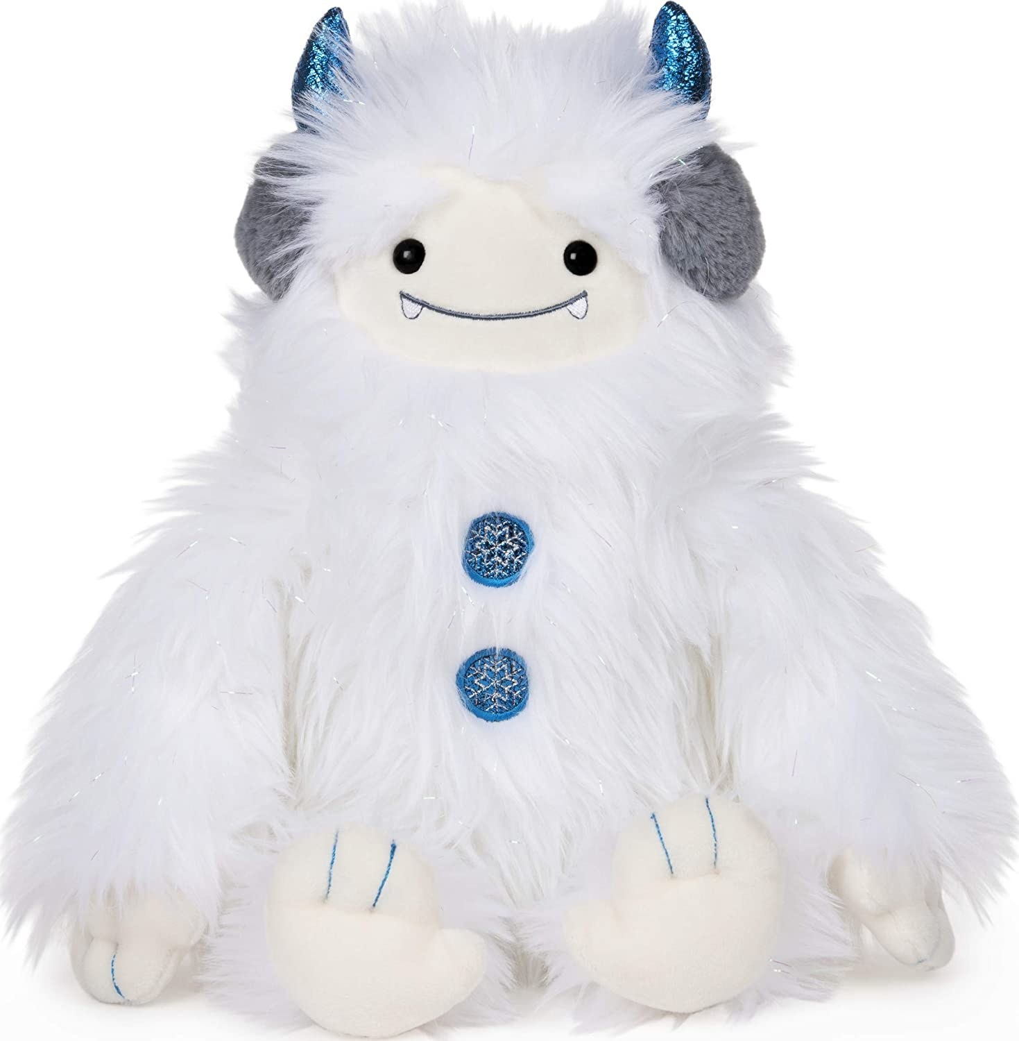 A furry white stuffed yeti doll with blue horns and buttons