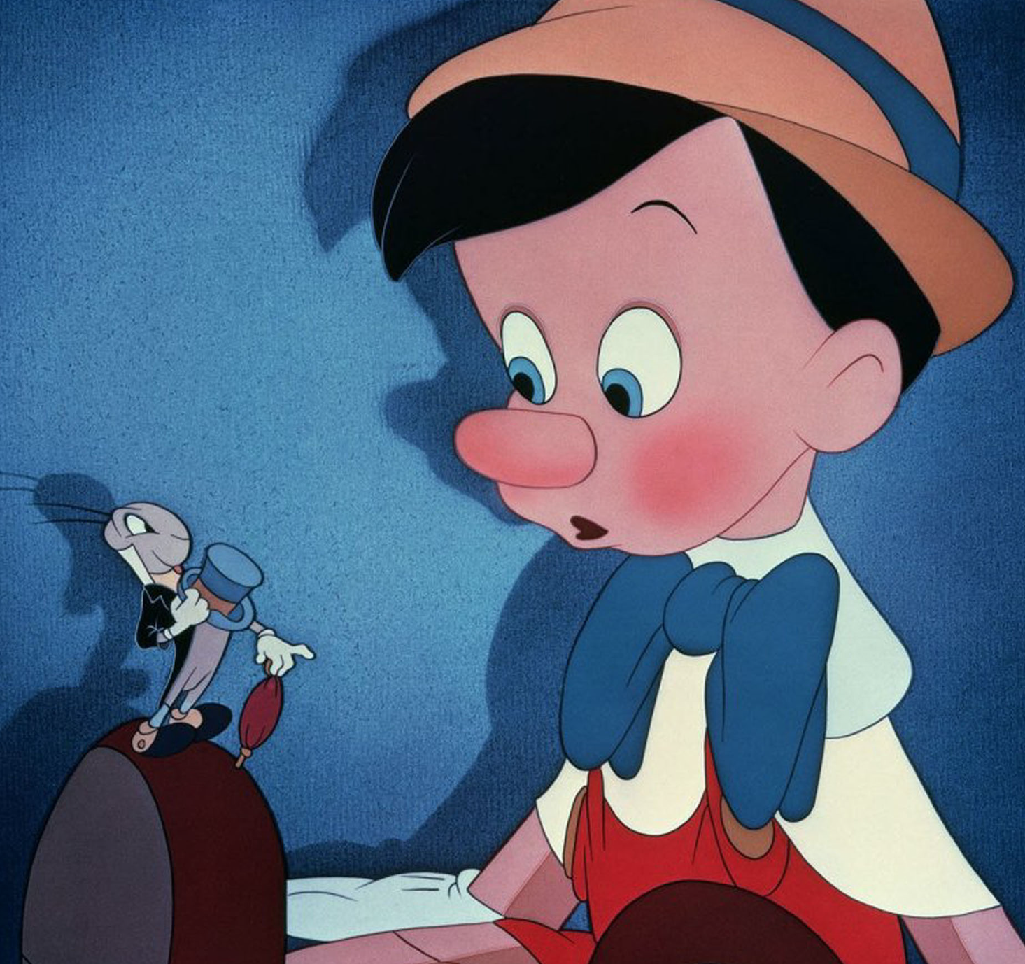 Dick Jones as Pinocchio and Cliff Edwards as Jiminy Cricket in the movie &quot;Pinocchio.&quot;