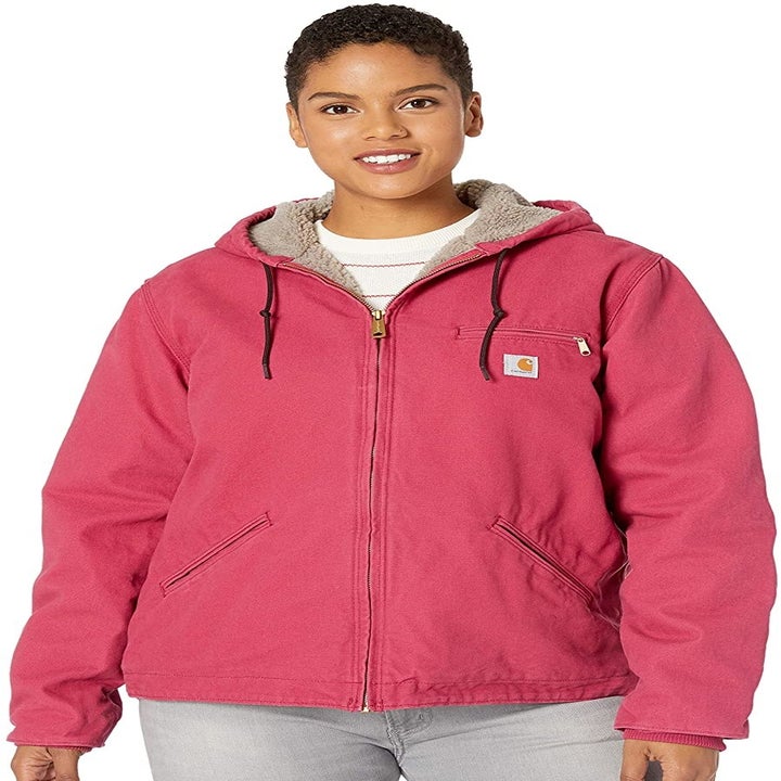 Plus size pink Carhartt jacket with lined interior, zipper, pull straps, front pockets, and hood 