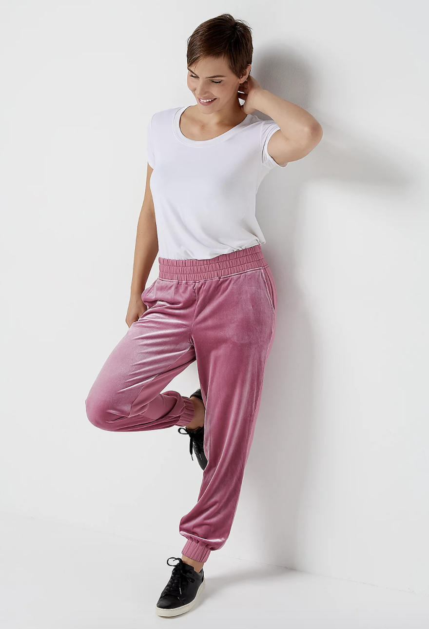 a model in pink velvet joggers