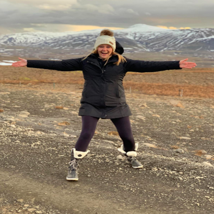 Reviewer wearing tights with a large jacket and boots in Iceland 