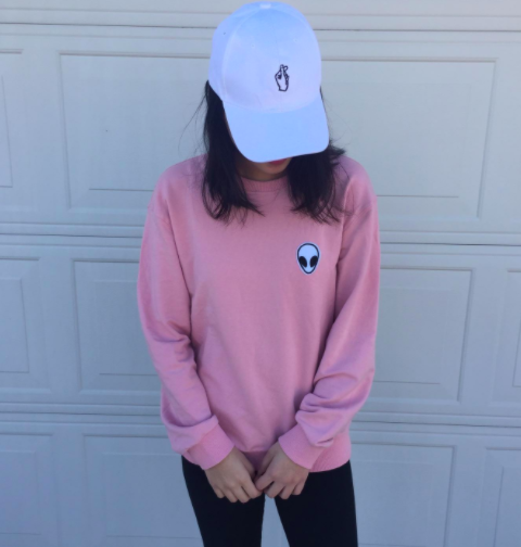 Reviewer wearing the pink alien pullover