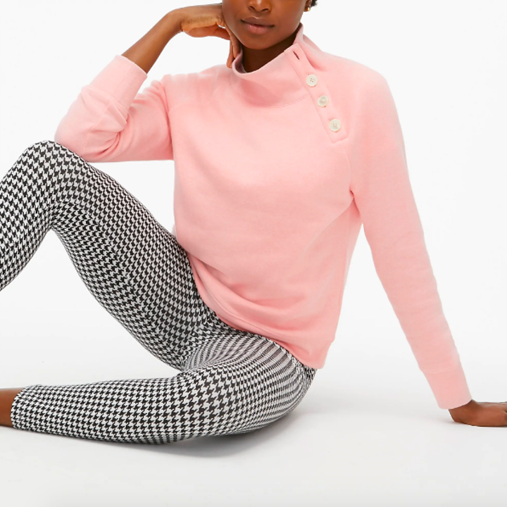 Pink turtleneck sweater with four buttons down neck to sleeve 