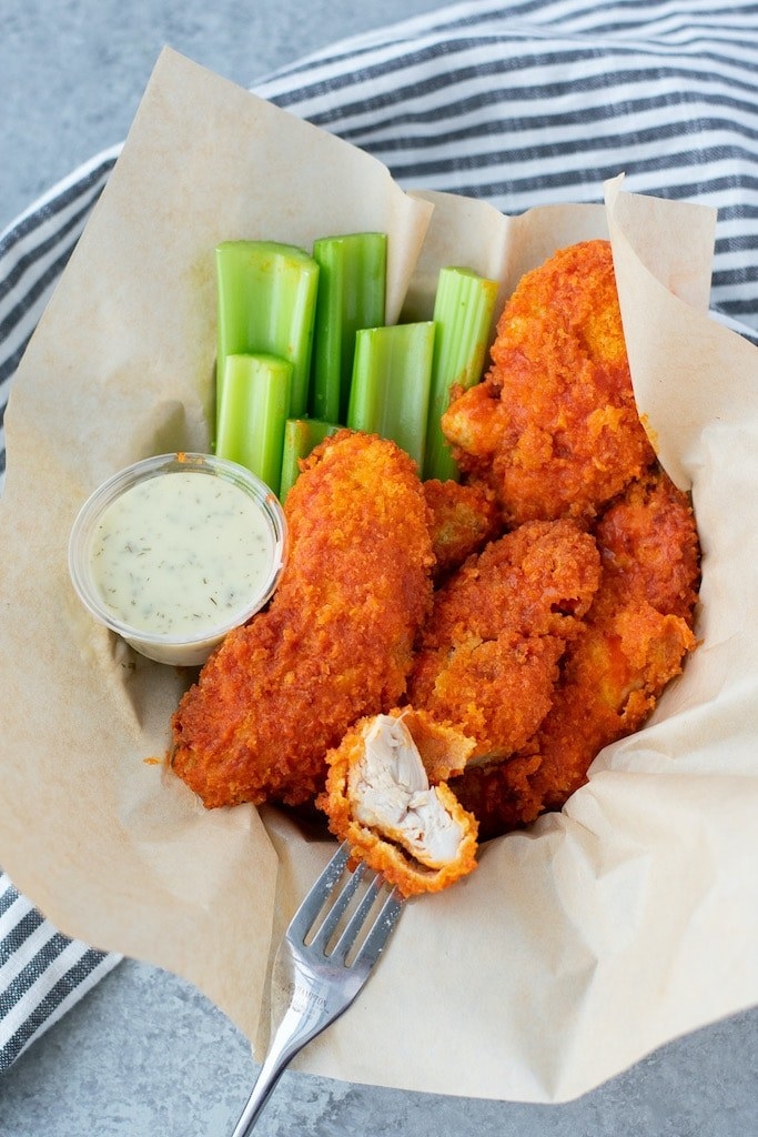 Crispy buffalo chicken tenders with celery and blue cheese dressing