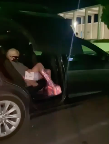 Lady Gaga exiting her car while wearing a mask to drop off her ballot