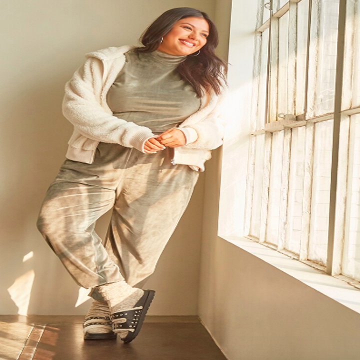 Crinkled velvet sweatsuit worn with jacket and sandals 