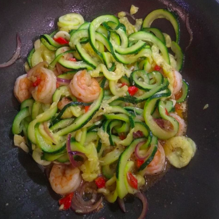 A reviewer photo of zucchini spirals being cooked with shrimp in a pan