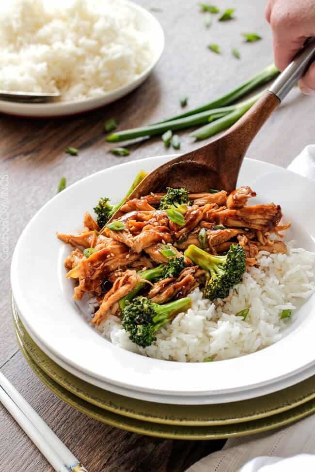 A plate of Mongolian chicken and broccoli over rice