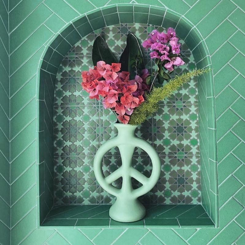 The vase shaped like a peace sign in teal