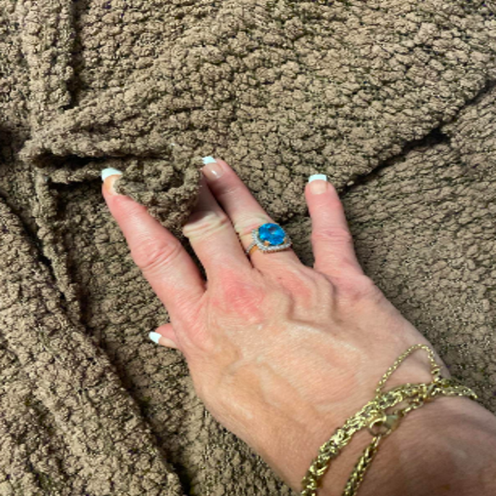 Reviewer showing closeup of "popcorn" material on sweater 