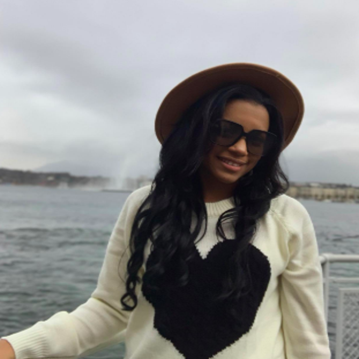 Reviewer wearing white sweater with large black heart in center