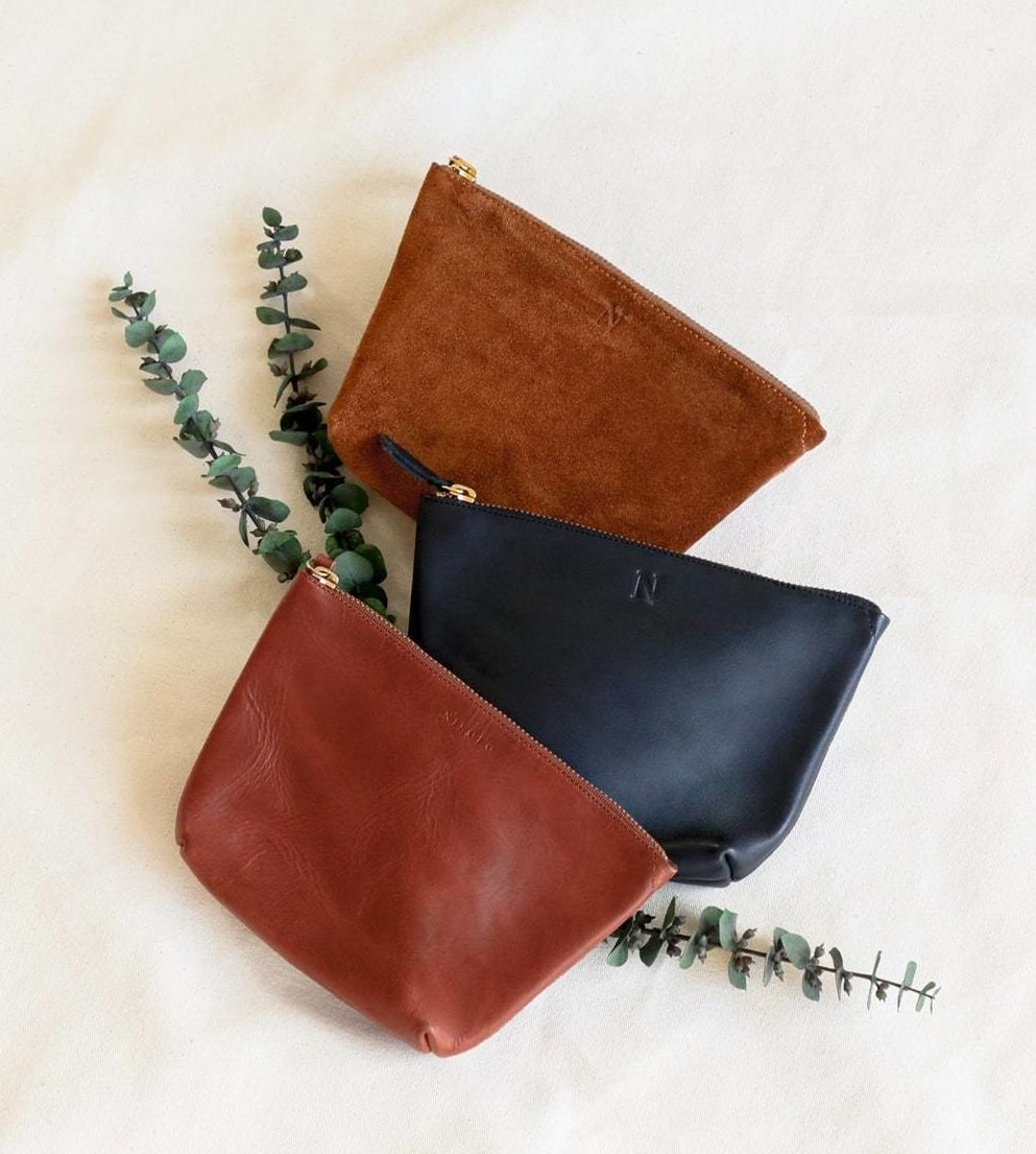 The brown and black leather pouches and the suede brown with zippers on the top