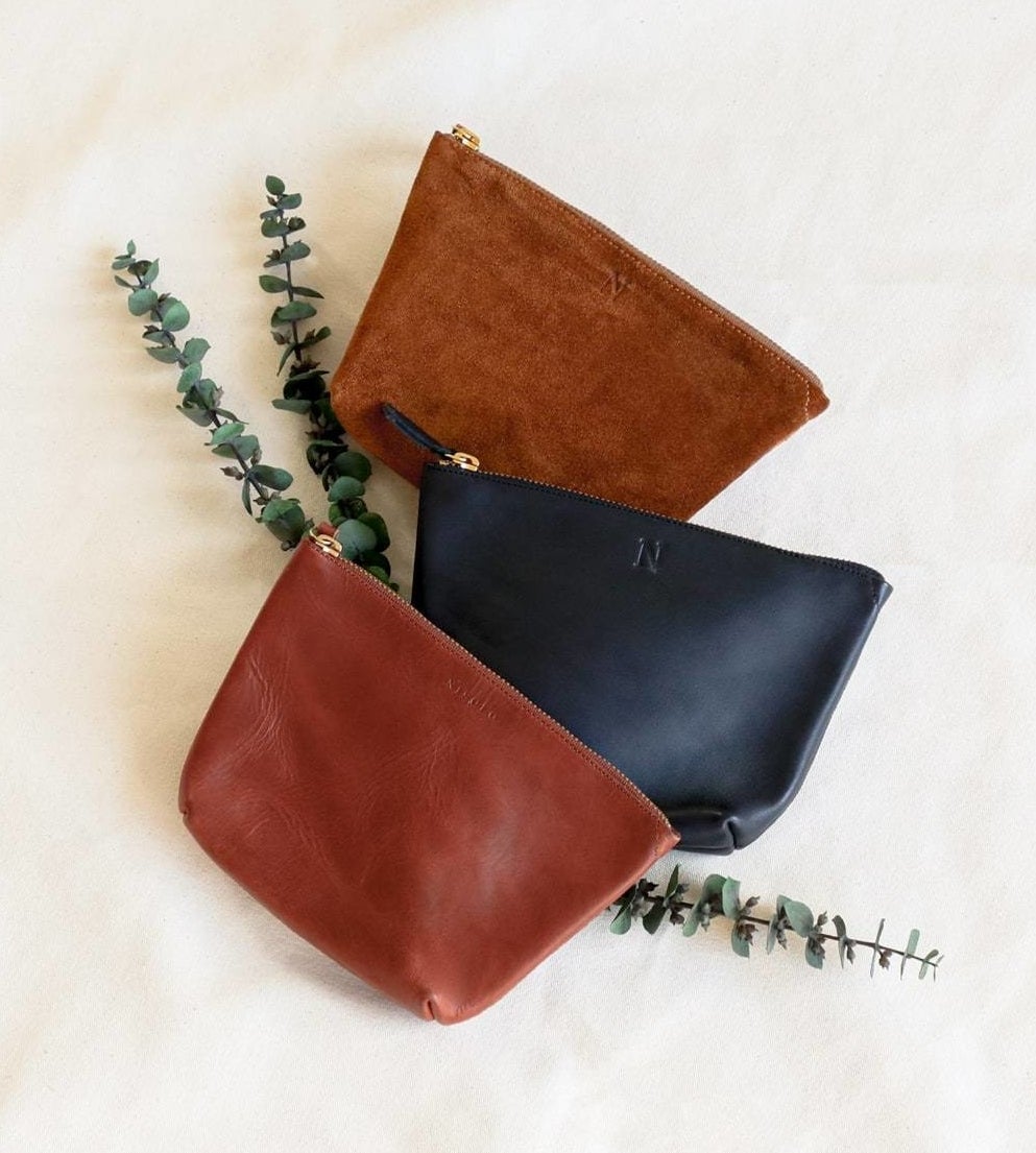 The brown and black leather pouches and the suede brown with zippers on the top