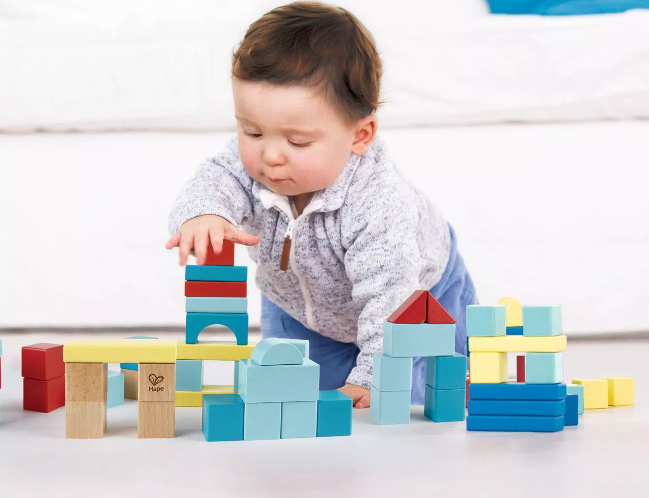 Child model playing with colorful building blocks