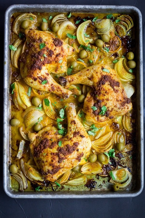 Roasted chicken on a sheet pan with onions and olives