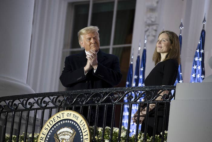 President Donald Trump applauding Amy Coney Barrett after her confirmation