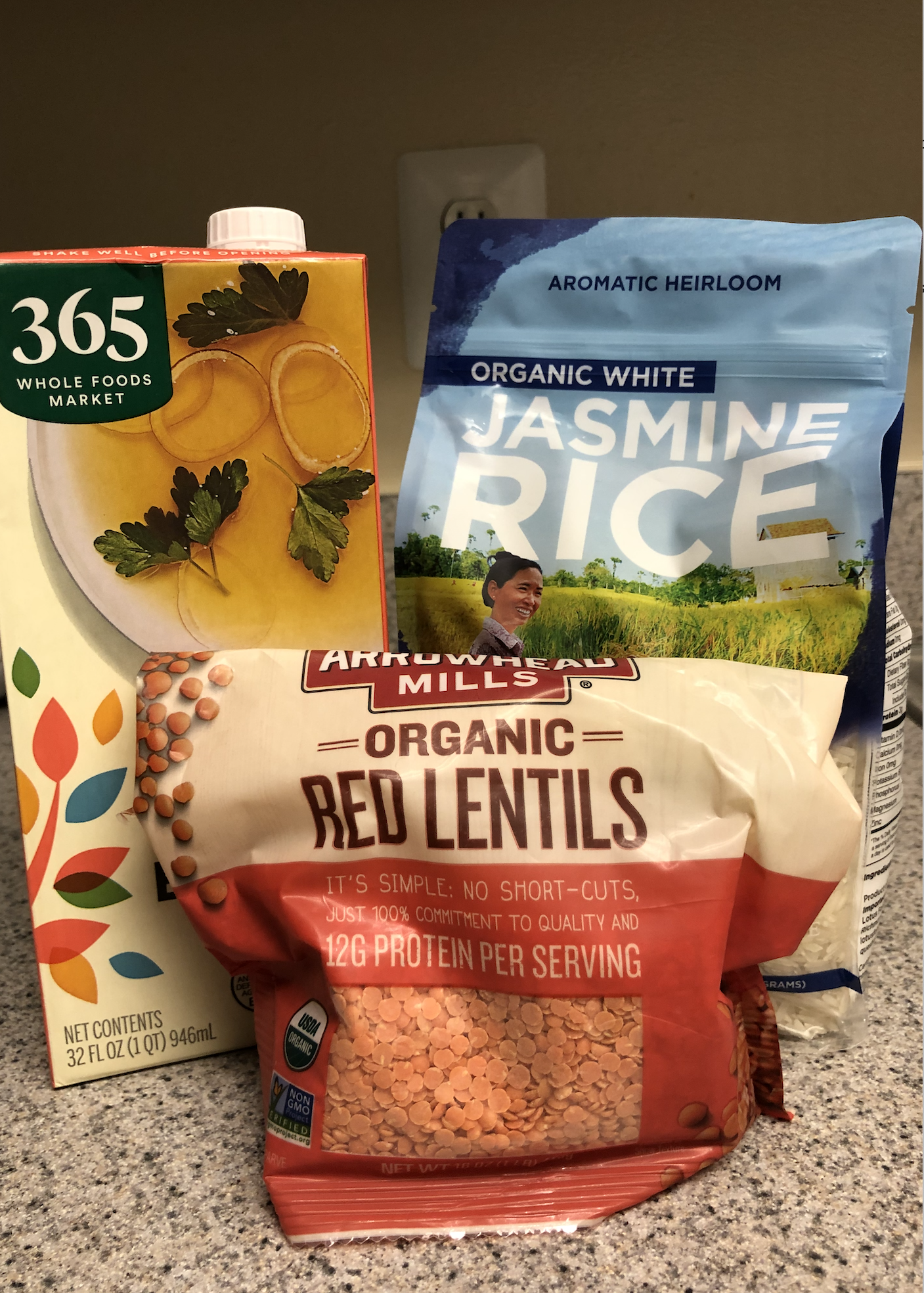 Stock, lentils, and jasmine rice on a countertop