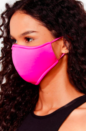 A person wears a face mask with elastic at the ears