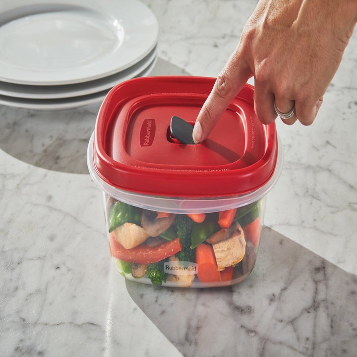 person hitting the vent in a rubbermaid container