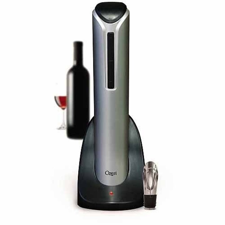 electric wine bottle opener on the charging stand with a pourer sitting at the bottom