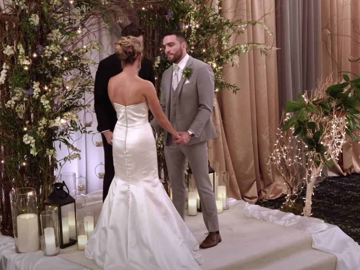 Mark and Jessica Batten at the alter on their wedding day