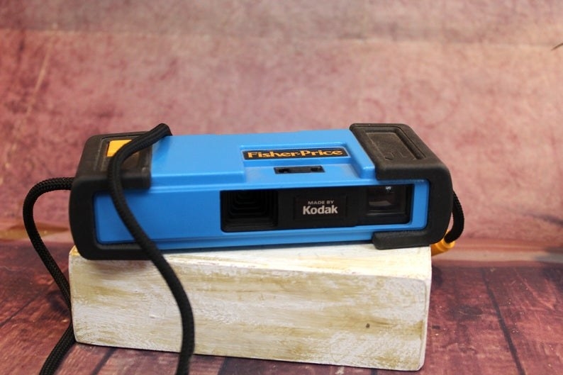 A blue Fisher-Price camera with &quot;Made by Kodak&quot; written it