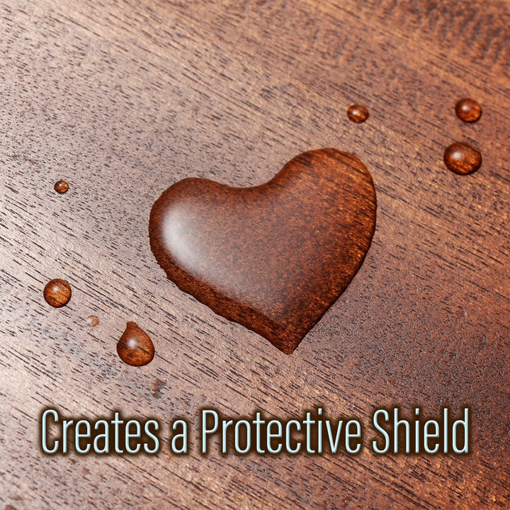 droplets of water sitting on top of a wooden surface