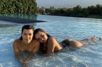 Kourtney Kardashian and Addison Rae hanging out in a pool together