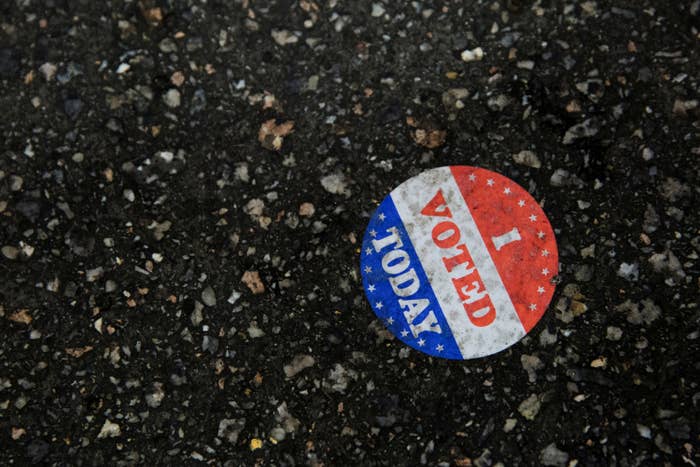 An "I Voted" sticker is stuck on the ground
