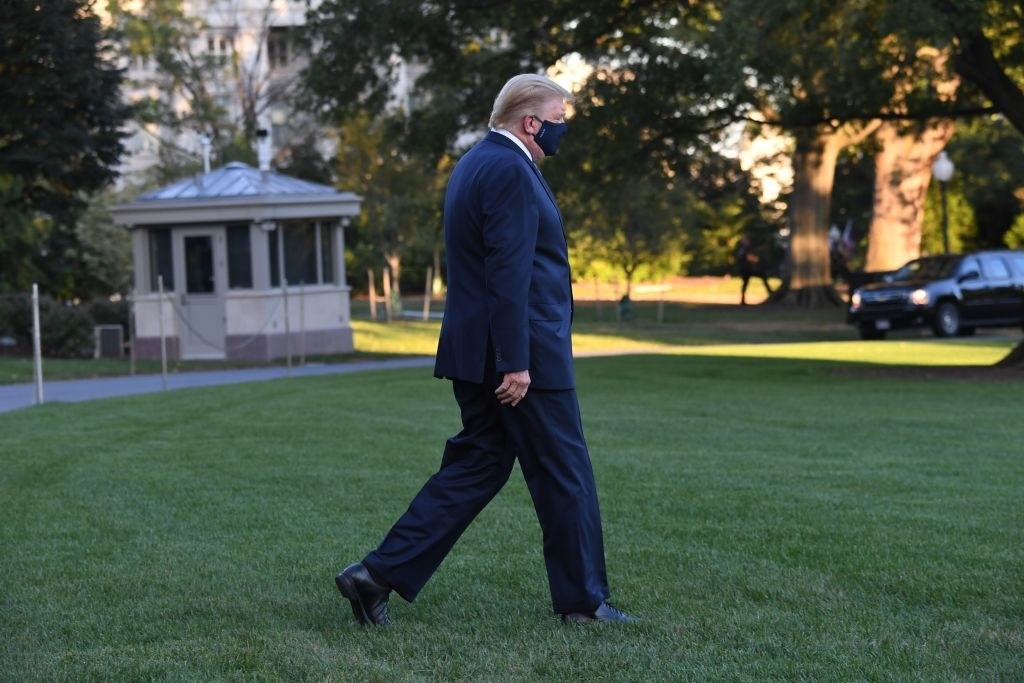 President Trump walks across the White House lawn  